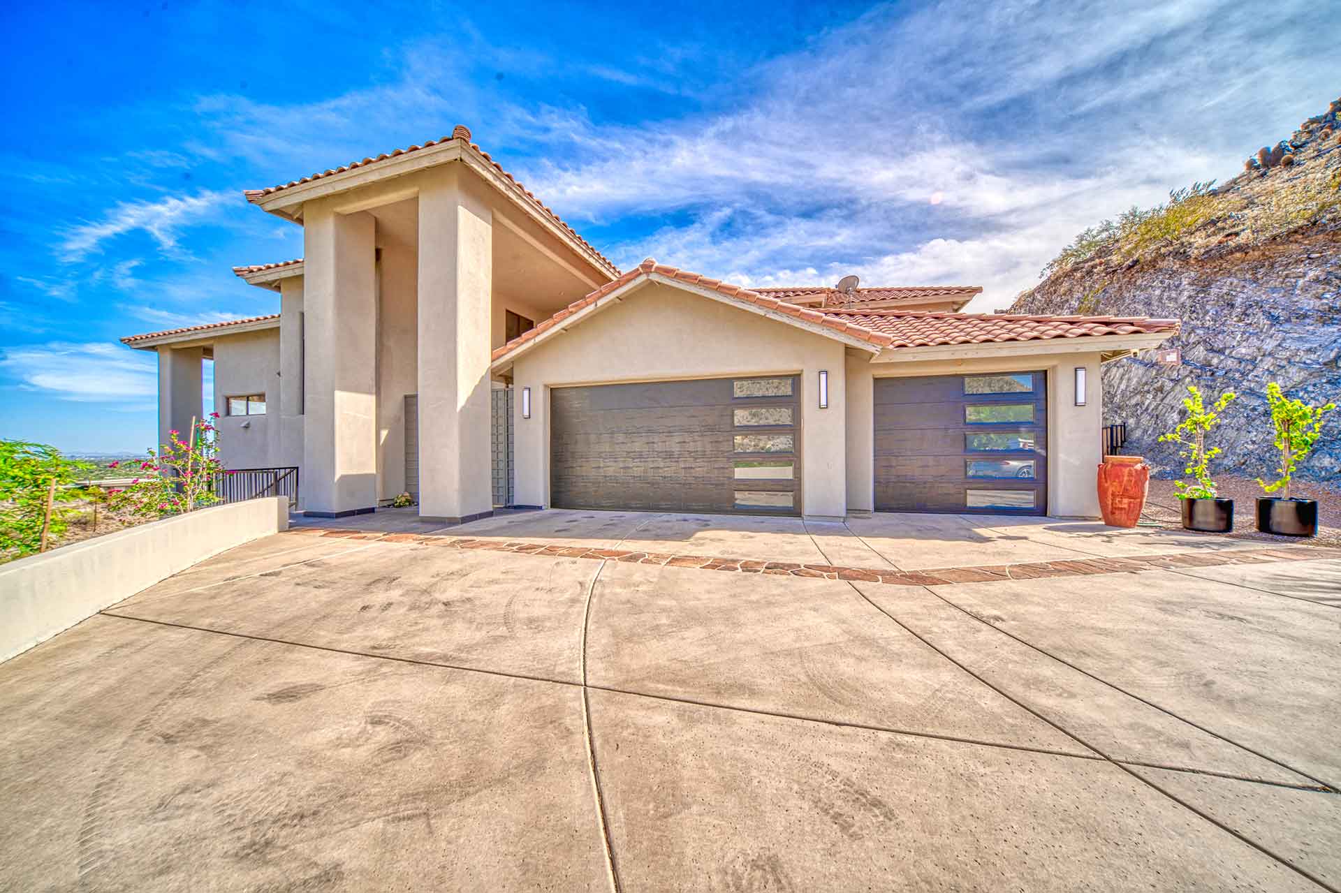 Real Blue Fox install: mosaic wood-look sectional garage doors on an East Valley home
